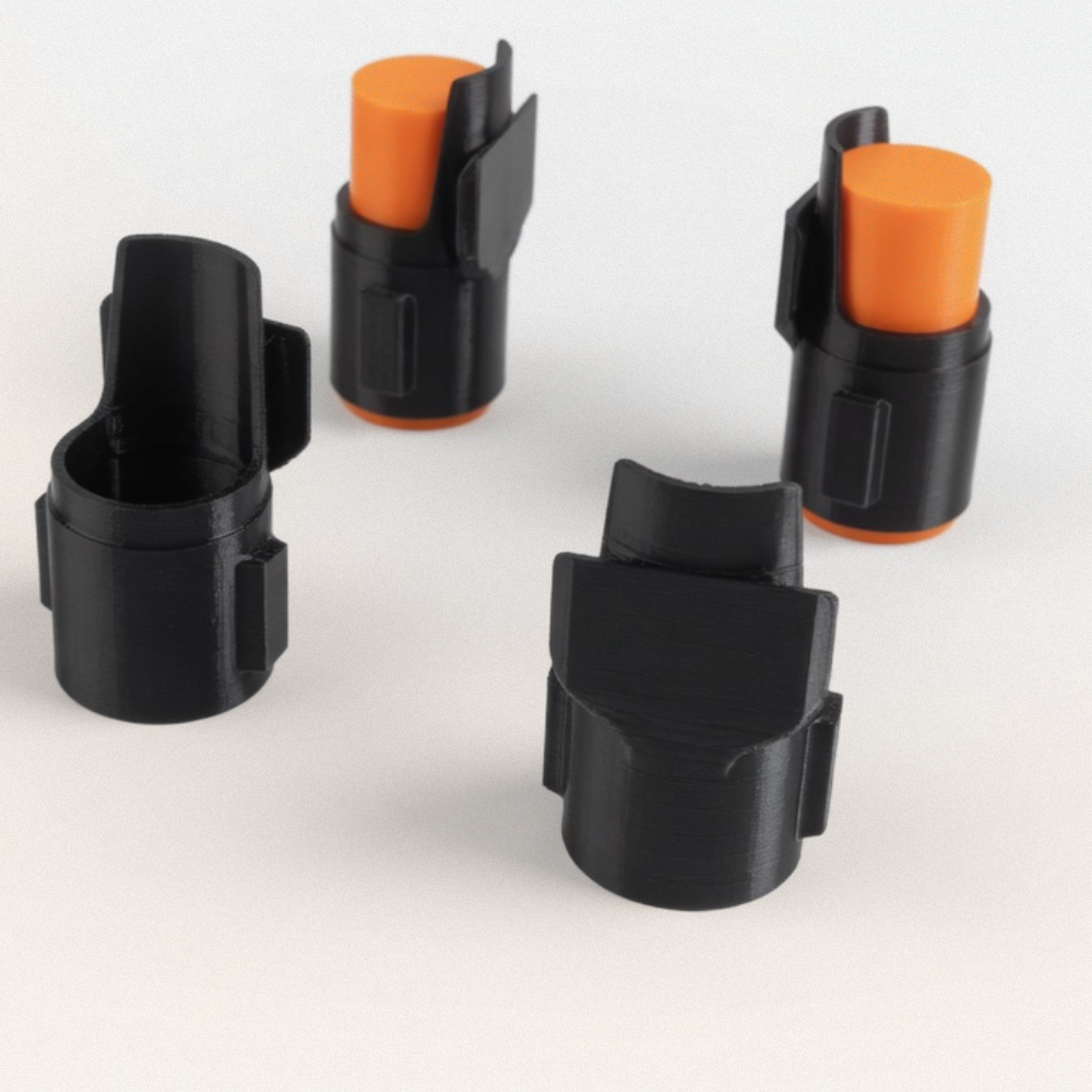 TP50 Compact Detents - Black 3D printed plastic detent mechanisms with orange shipping protectors on white background