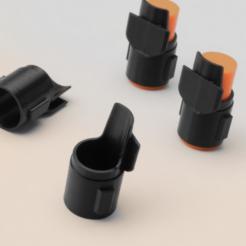 TP 50 Compact Detents black 3D printed plastic mechanisms with orange shipping caps, product photography on white background